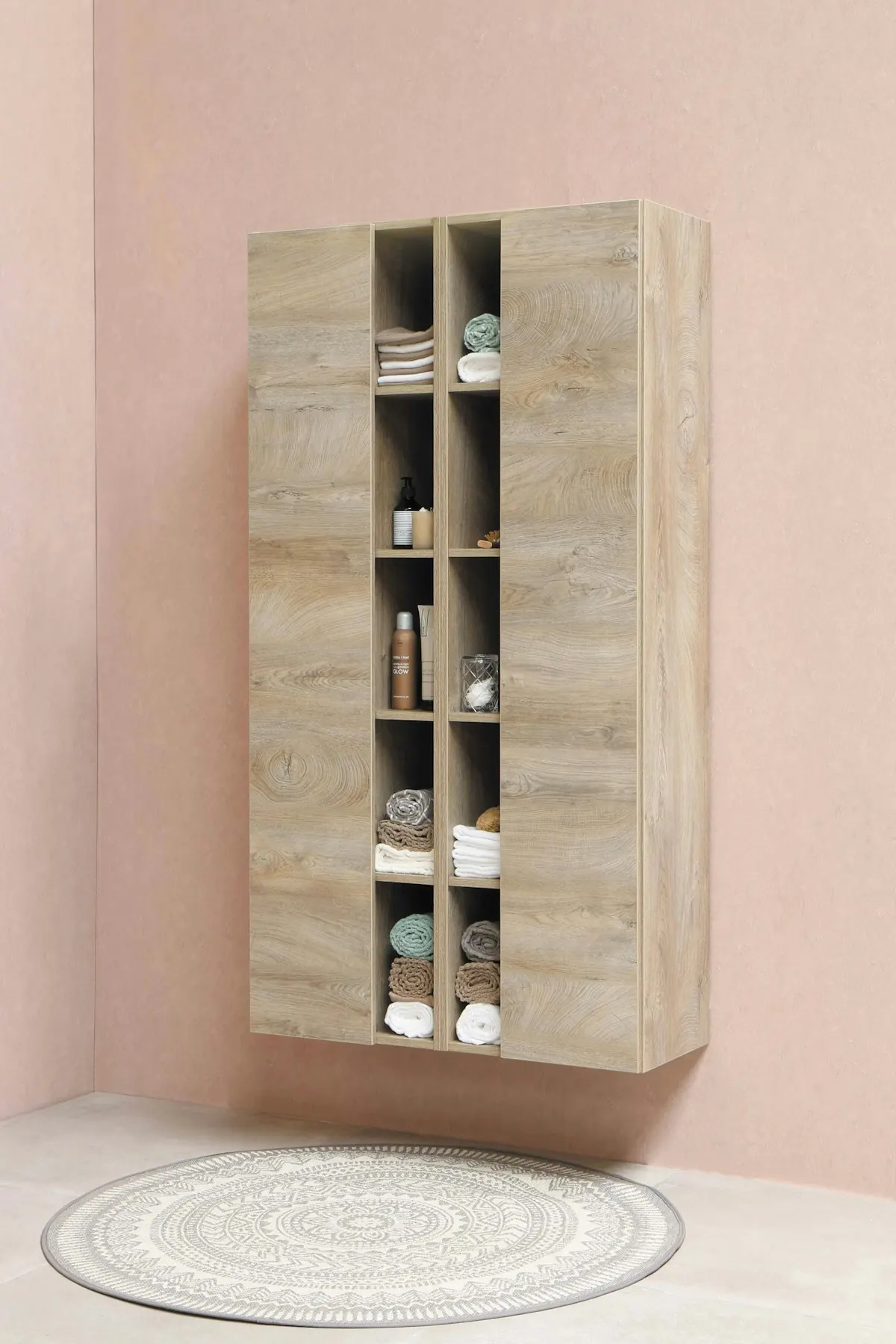 Tall open shelving unit with neatly stacked towels and supplies