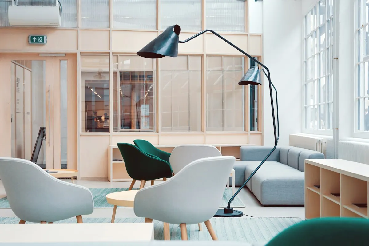 Bright shared workspace with desks, lamps and storage cubbies