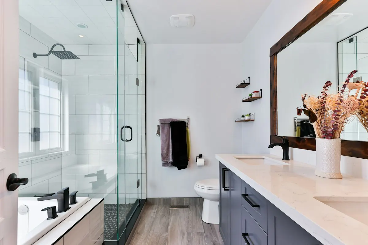 Clean white bathroom with a glass shower and floating vanity